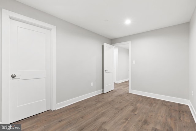 unfurnished bedroom featuring dark hardwood / wood-style flooring