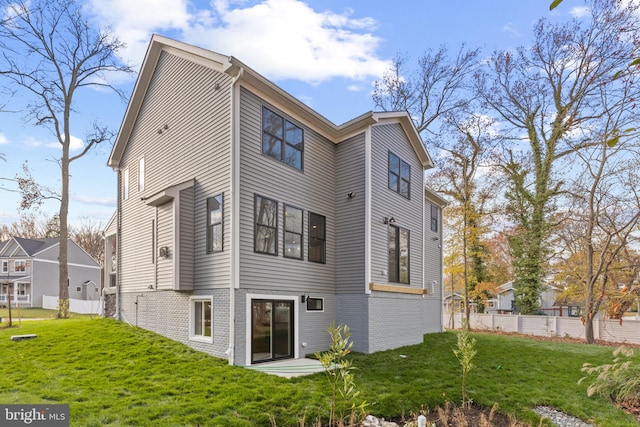 rear view of property with a yard