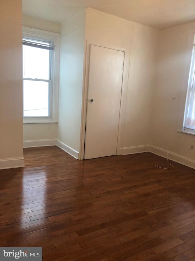 unfurnished bedroom featuring dark wood-type flooring