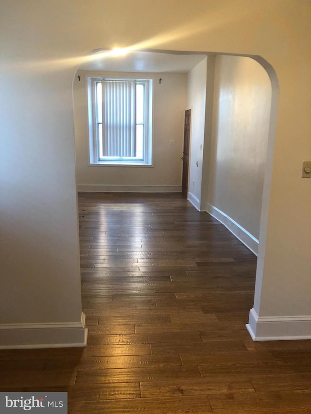 spare room featuring dark wood-type flooring