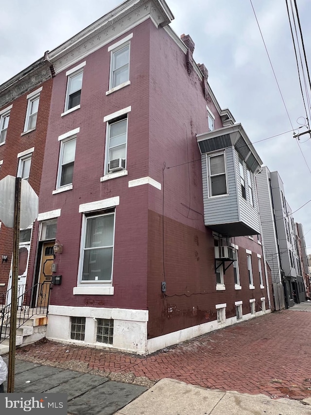 view of side of home featuring cooling unit