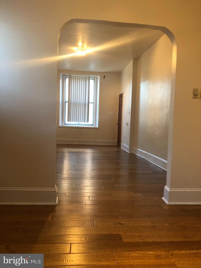 empty room with dark hardwood / wood-style floors