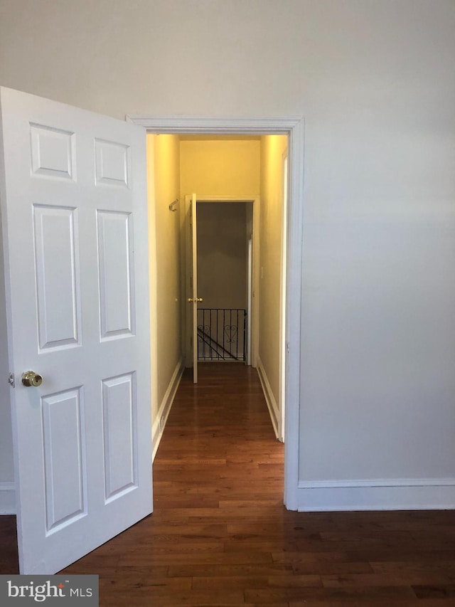 hall with dark hardwood / wood-style flooring