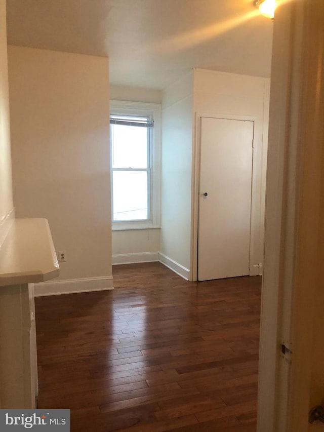 spare room with dark hardwood / wood-style floors