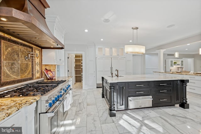 kitchen with premium range hood, ornamental molding, high end stove, white cabinetry, and hanging light fixtures