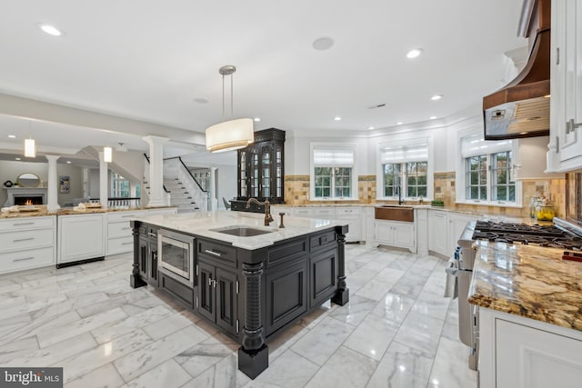 kitchen with tasteful backsplash, extractor fan, stainless steel appliances, and white cabinets