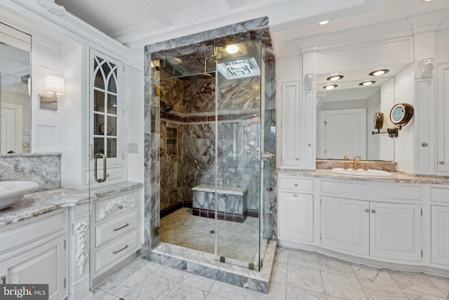 bathroom with vanity, backsplash, and a shower with door