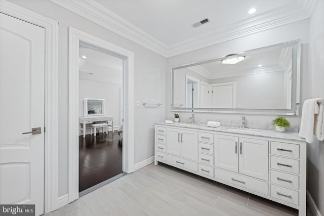 bathroom featuring vanity and ornamental molding