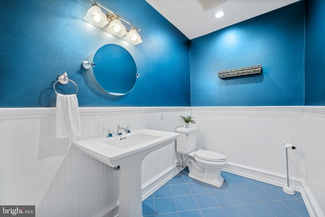 bathroom with tile patterned flooring and toilet