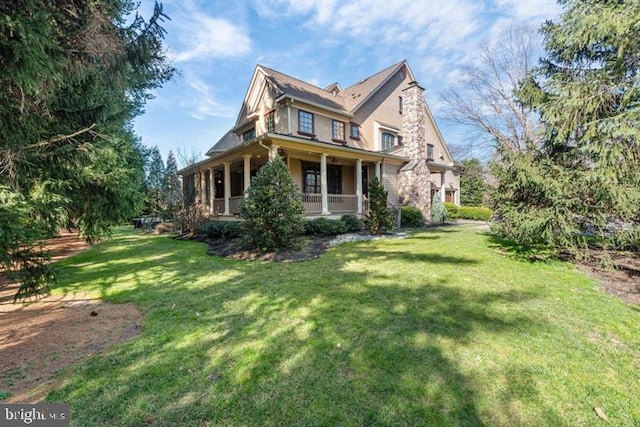 view of home's exterior with a porch and a yard