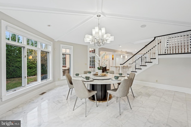 dining area with lofted ceiling with beams and a chandelier