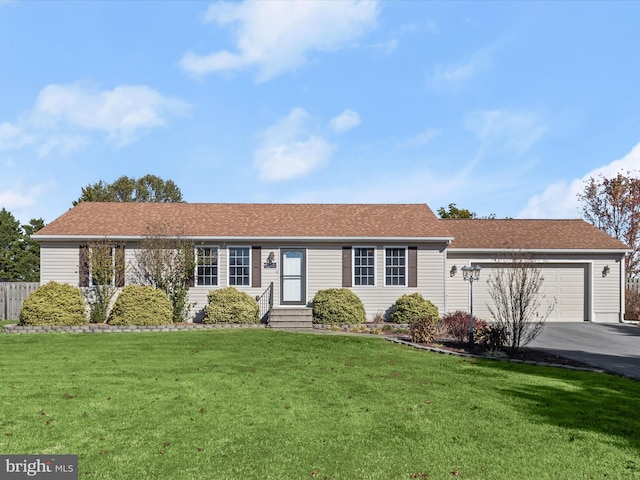 ranch-style house with a garage and a front lawn