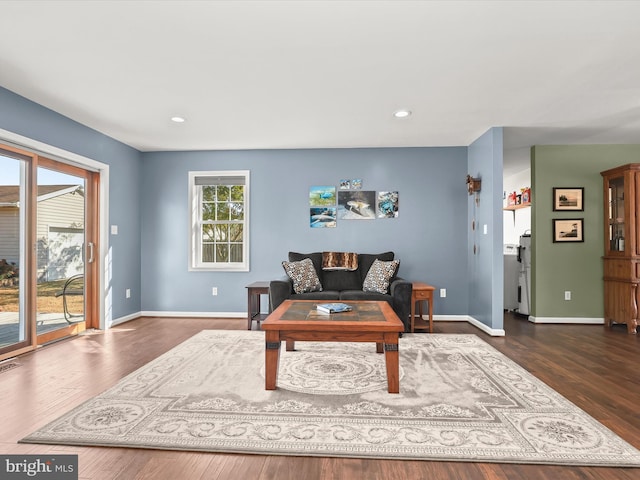 living room with dark hardwood / wood-style flooring