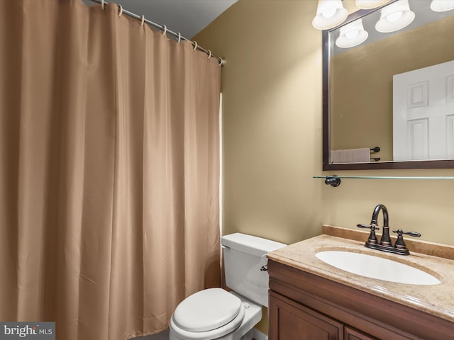 bathroom featuring toilet and vanity