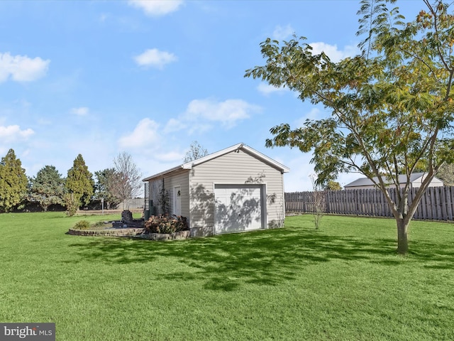 view of yard featuring a garage and an outdoor structure