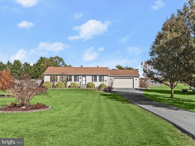 single story home featuring a garage and a front lawn