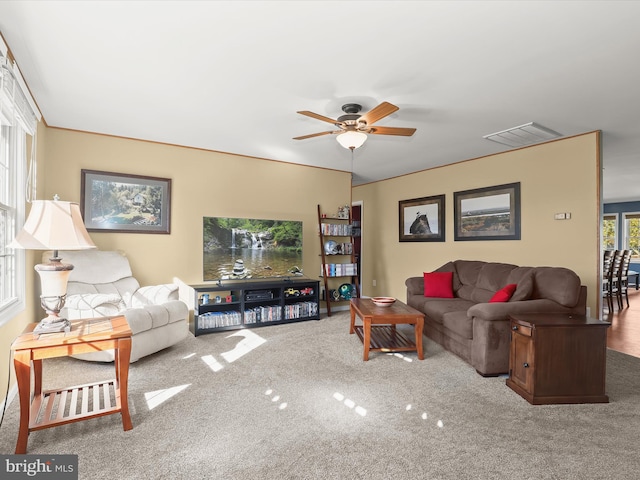 living room with carpet floors and ceiling fan