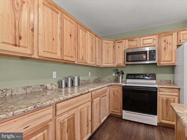 kitchen with light brown cabinets, dark hardwood / wood-style flooring, light stone counters, and white appliances