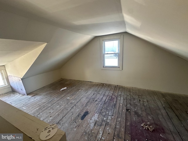 additional living space with wood-type flooring and lofted ceiling