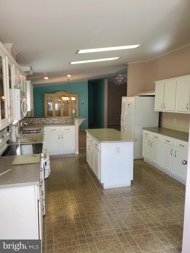 kitchen with white cabinetry, white appliances, and a kitchen island