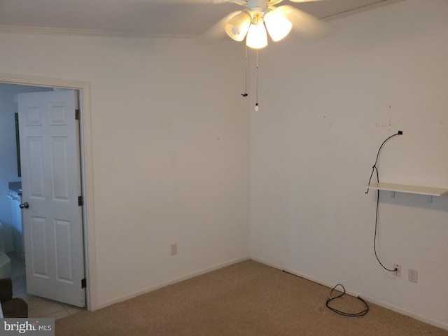 carpeted spare room featuring ceiling fan