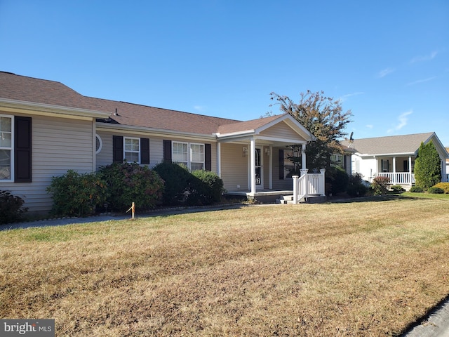 ranch-style house with a front lawn and covered porch