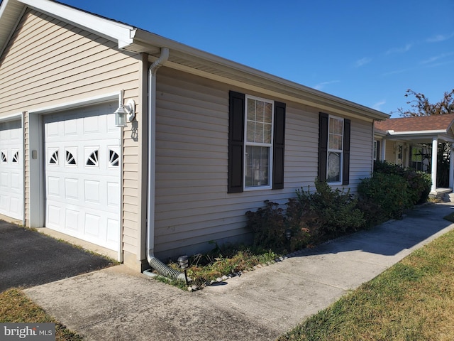 view of side of home featuring a garage