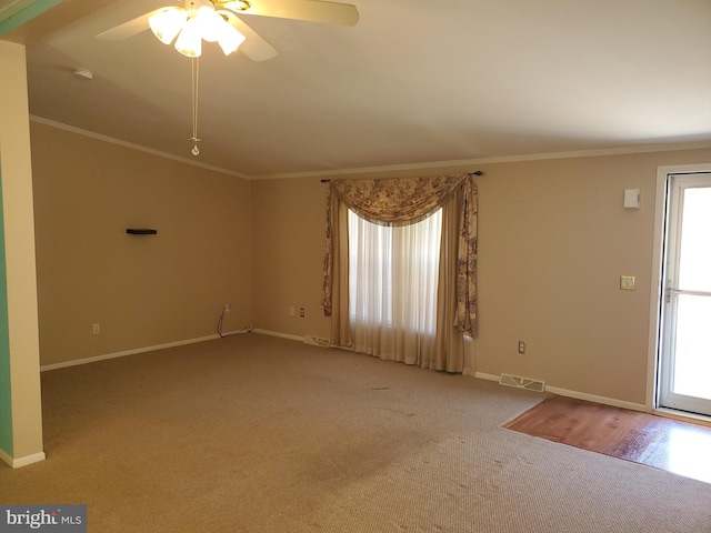 unfurnished room featuring crown molding, carpet floors, and ceiling fan