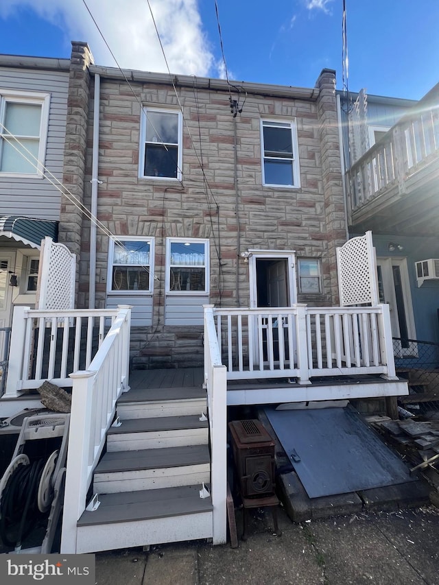 back of house with a wooden deck