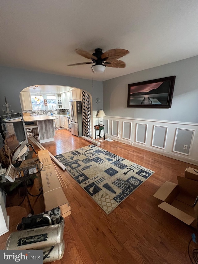 living room with ceiling fan and hardwood / wood-style flooring