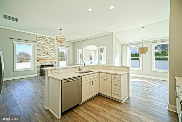 kitchen featuring white cabinetry, sink, stainless steel dishwasher, and plenty of natural light