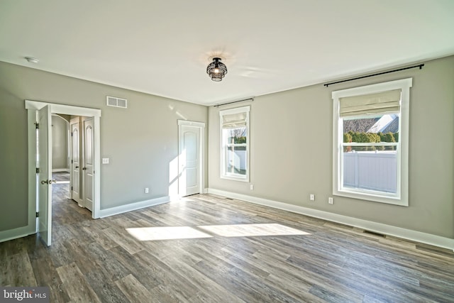 empty room with hardwood / wood-style floors