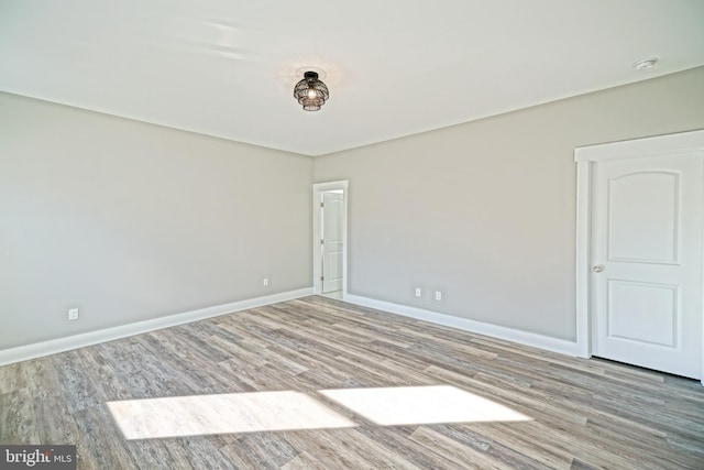 empty room with light hardwood / wood-style flooring