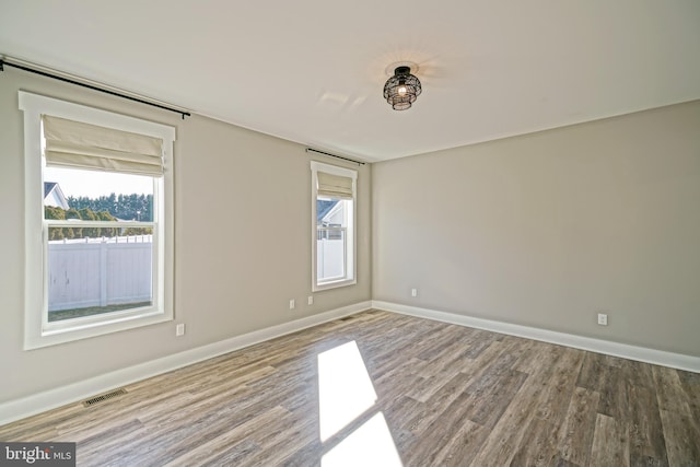 unfurnished room featuring wood-type flooring