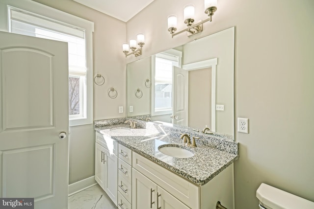 bathroom with vanity, toilet, and plenty of natural light