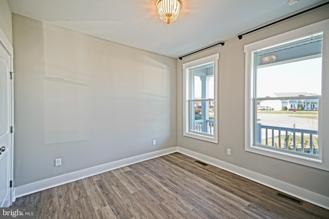 empty room with hardwood / wood-style flooring