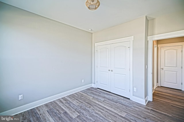 unfurnished bedroom featuring dark hardwood / wood-style flooring