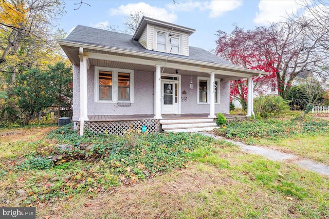 view of front of home with a porch and cooling unit