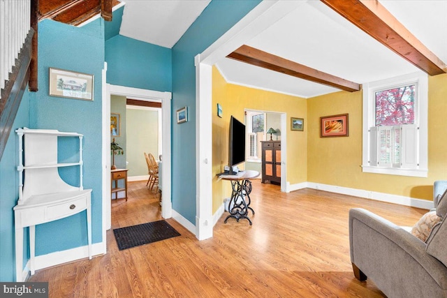 interior space with beamed ceiling and light wood-type flooring