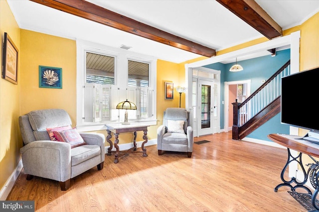 sitting room with beam ceiling and light hardwood / wood-style floors