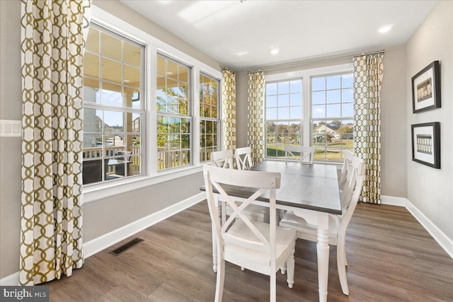 dining room featuring hardwood / wood-style flooring and a healthy amount of sunlight