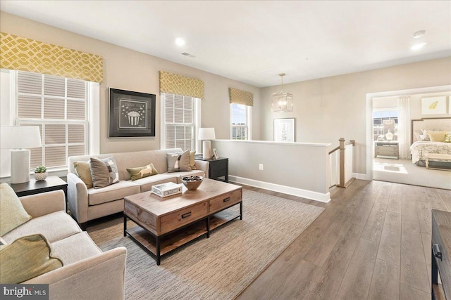 living room with a chandelier and hardwood / wood-style flooring