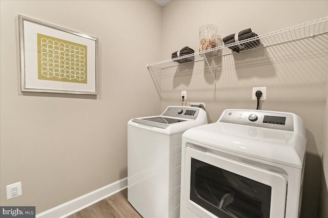 laundry room featuring hardwood / wood-style flooring and independent washer and dryer