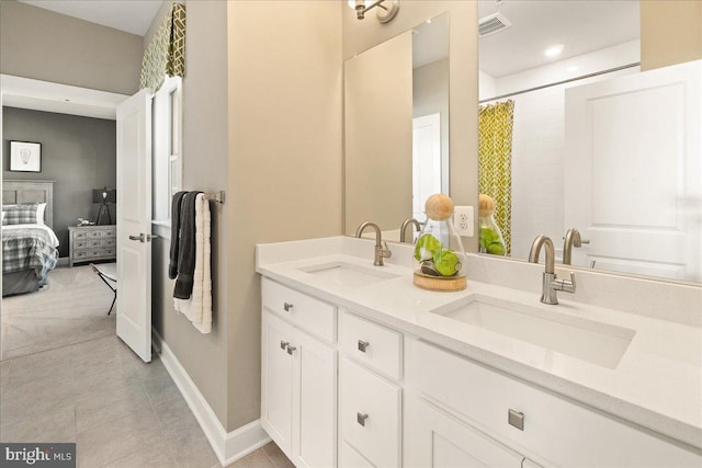 bathroom with tile patterned flooring and vanity