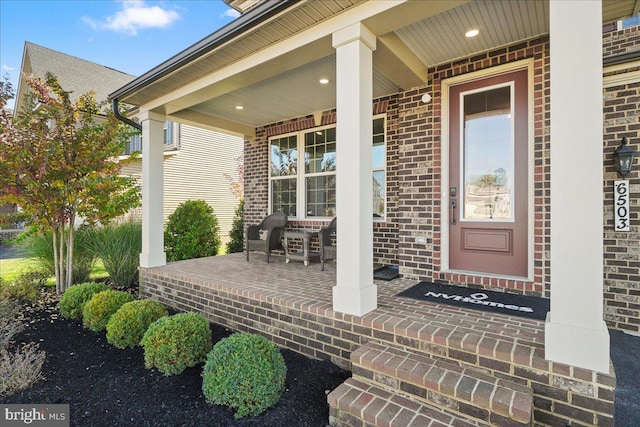 view of exterior entry with covered porch