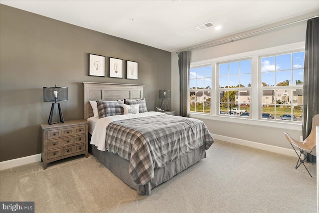 carpeted bedroom featuring multiple windows