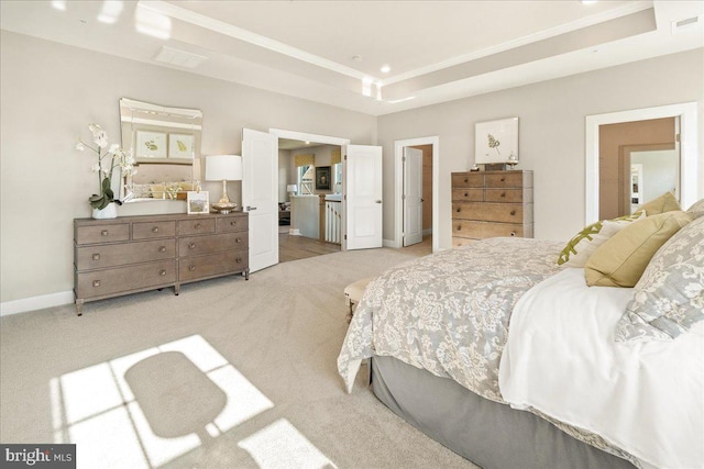 carpeted bedroom with a tray ceiling and crown molding