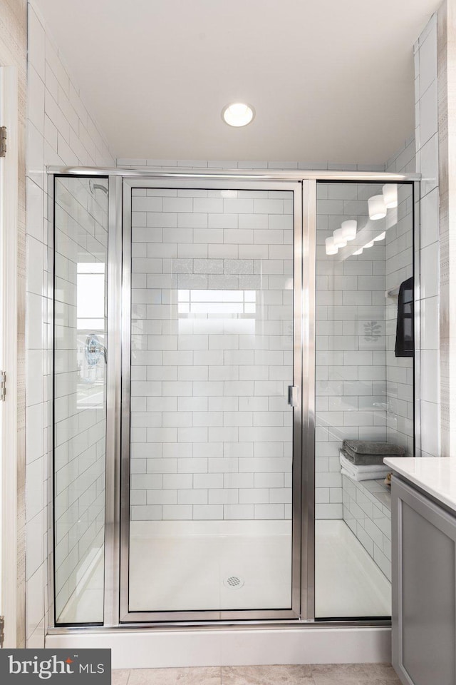 bathroom featuring a stall shower and recessed lighting