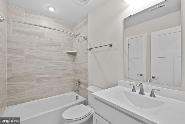 full bathroom featuring toilet, vanity, and tiled shower / bath combo