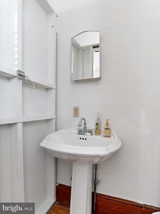 bathroom with sink and parquet flooring